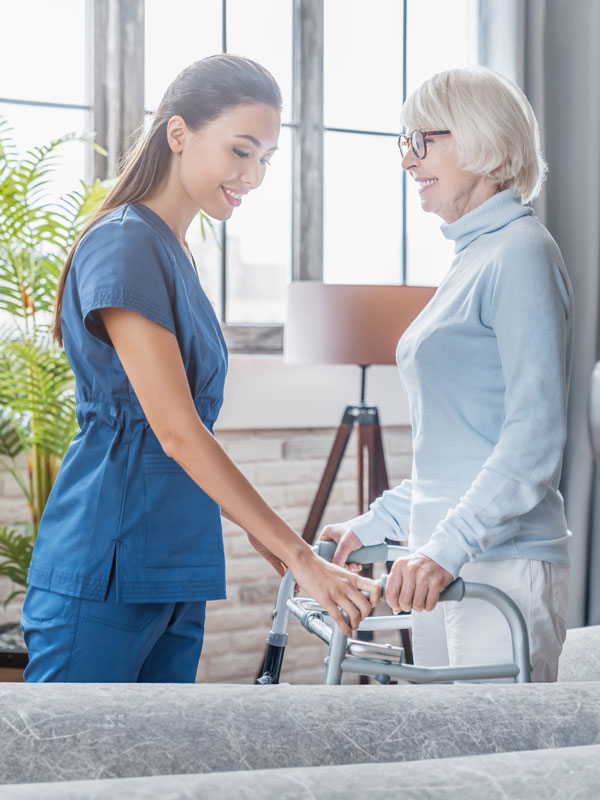 healthcare employee helping senior woman
